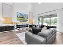 Bright living room showcasing soaring ceilings, a fireplace, and a large sliding glass door at 4188 Barbour Trl, Odessa, FL 33556