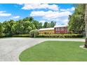 Beautiful property showcasing a spacious lawn, mature trees, and a classic two-story home at 4541 School Rd, Land O Lakes, FL 34638