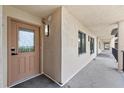 Exterior hallway with door to condo, a window, and a view down the hallway with black railings at 4550 Bay Blvd # 1231, Port Richey, FL 34668