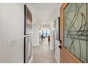 Inviting entryway with elegant tile flooring, artwork, and a clear view into the living room with water views at 4550 Bay Blvd # 1231, Port Richey, FL 34668
