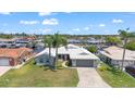 An aerial view of the property featuring manicured landscaping, and neighborhood canal views at 4918 Forecastle Dr, New Port Richey, FL 34652