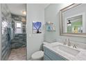 Well-lit bathroom featuring a modern vanity and a tiled walk-in shower at 4918 Forecastle Dr, New Port Richey, FL 34652