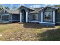 Charming blue home with a landscaped front yard and well maintained yard at 5294 Elkin Ave, Spring Hill, FL 34606