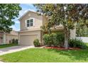 Charming two-story home featuring a well-manicured lawn and a two-car garage at 6125 Desert Peace Ave, Land O Lakes, FL 34639