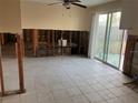 Renovation-ready kitchen featuring exposed wall studs, tile floors, and sliding glass door to outside at 6205 Westport Dr, Port Richey, FL 34668