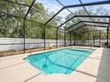 Sparkling screened-in pool with ample deck space perfect for relaxing or entertaining at 6273 Pinehurst Dr, Spring Hill, FL 34606