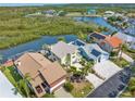 Aerial view of waterfront homes nestled amongst mangroves and featuring private docks for boating and fishing at 6321 Garland Ct, New Port Richey, FL 34652