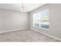 Bright living room featuring neutral walls, large window, and tile flooring at 6440 Curtiss Ln, Spring Hill, FL 34609