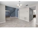 Open concept living room with staircase and tile flooring at 6440 Curtiss Ln, Spring Hill, FL 34609