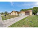 Charming one-story home with stucco exterior, attached garage, and a driveway at 7035 Cutty Sark Dr, Port Richey, FL 34668