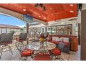 Inviting covered outdoor patio with seating area, television, bar, and a birdcage at 713 715 W Fribley St, Tampa, FL 33603