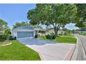 Well maintained home with pristine landscaping, long driveway, and two car garage at 7499 Blue Skies Dr, Spring Hill, FL 34606