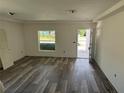 This living room boasts new hardwood floors, fresh paint, and a large window, ready for personalization at 7583 St Andrews Blvd, Weeki Wachee, FL 34613