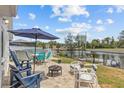 Enjoy the outdoors on this lovely stone patio with comfortable seating, a fire pit, and an above ground pool for relaxation at 7626 Hatteras Dr, Hudson, FL 34667