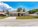 Charming single-story home with a two-car garage and well-maintained lawn at 8126 Wooden Dr, Spring Hill, FL 34606