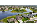 A beautiful aerial view of an upscale residential neighborhood showcasing multiple homes and a small lake at 9125 Palm Beach Dr, Brooksville, FL 34613