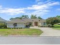 Desirable home featuring manicured landscaping, a double-door entry, and a serene neighborhood setting at 9216 Tarleton Cir, Weeki Wachee, FL 34613