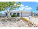 Inviting one-story home with mature trees, mailbox and a two-car garage with classic curb appeal at 9942 Woodridge Ct, Port Richey, FL 34668