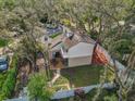 A high angle back exterior view showing backyard patio and upper level balcony at 10910 Winter Oak Pl, Tampa, FL 33618