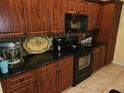 Well-equipped kitchen featuring stainless steel appliances, granite countertops, and custom wood cabinets at 12270 Clarendon Ct, Spring Hill, FL 34609