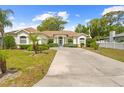 Charming single-story home with well-maintained lawn, light-colored exterior and a lovely extended driveway at 1245 Coble E Rd, Spring Hill, FL 34608