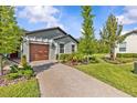 View of a well-maintained home featuring a brick driveway and lush green landscaping at 16793 Forge Surf St, Land O Lakes, FL 34638