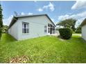 A cozy screened in porch overlooks the home's backyard at 18109 Webster Grove Dr, Hudson, FL 34667