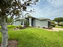 Well-manicured lawn complements this home's exterior at 18109 Webster Grove Dr, Hudson, FL 34667