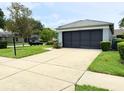 Single-story home showing the driveway and screened garage at 18109 Webster Grove Dr, Hudson, FL 34667