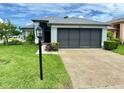Lovely single-story home featuring a two-car garage, manicured lawn, and a welcoming entrance at 18109 Webster Grove Dr, Hudson, FL 34667