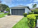 Spacious two-car garage with a clean driveway and landscaping, adding curb appeal at 18109 Webster Grove Dr, Hudson, FL 34667