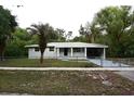 Charming single-story home with a well-maintained lawn, mature trees, and freshly painted exterior at 18838 Rosephil St, Spring Hill, FL 34610
