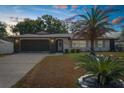 Charming one-story home with a well-manicured lawn and a spacious driveway at sunset at 2192 Meredith Dr, Spring Hill, FL 34608