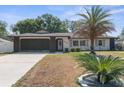 Charming one-story home with a well-manicured lawn and a spacious driveway at 2192 Meredith Dr, Spring Hill, FL 34608