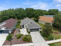 Aerial view of a well-manicured home featuring mature landscaping, and a two-car garage at 261 Rochester St, Spring Hill, FL 34609