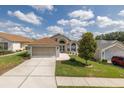 Charming single-story home with an attached two-car garage, manicured lawn, and a pristine front yard at 284 Quane Ave, Spring Hill, FL 34609