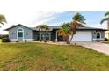 Well-maintained single-story home with a tidy lawn and decorative landscaping at 305 Yellow Elder, Punta Gorda, FL 33955