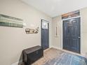 Foyer featuring a bench, coat hooks, and a 'Welcome' sign, all in neutral tones at 4740 Tuscan Loon Dr, Tampa, FL 33619