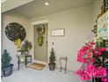 Cozy front entry with decorations, plants, door wreath and 'Summer Vibes' welcome mat at 4740 Tuscan Loon Dr, Tampa, FL 33619