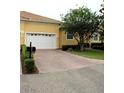 Inviting home exterior with well-maintained lawn, brick-paved driveway, and a one car garage at 4837 Rainbow Race, New Port Richey, FL 34652