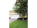 Inviting home exterior featuring a well-maintained lawn, brick-paved driveway, and an attached one car garage at 4837 Rainbow Race, New Port Richey, FL 34652