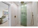 Modern bathroom with walk-in shower, rain shower head, and green tile accent wall at 4939 Floramar Ter # 902, New Port Richey, FL 34652