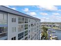 Condominium building showcasing large windows providing ample natural light and marina views at 4939 Floramar Ter # 902, New Port Richey, FL 34652