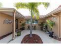 Charming front courtyard with seating and lush landscaping adds curb appeal at 5008 Forecastle Dr, New Port Richey, FL 34652
