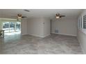 Spacious living room with neutral tile floors and large windows at 5008 Forecastle Dr, New Port Richey, FL 34652