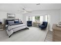 Bright main bedroom with large windows, sitting area and king size bed at 5512 Tropic Dr, New Port Richey, FL 34653
