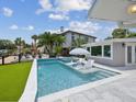 Backyard pool area featuring a pool, spa and outdoor seating with umbrella at 5512 Tropic Dr, New Port Richey, FL 34653