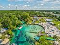 Beautiful aerial view of Weeki Wachee Springs with vibrant water, sandy beach, and abundant recreational activities at 6076 Shiprock Ave, Spring Hill, FL 34608