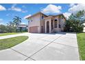 Exterior elevation of a two-story home with large driveway and manicured lawn at 6340 Spoonbill Dr, New Port Richey, FL 34652
