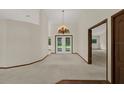 Elegant living room showcases a chandelier, neutral walls, and views to the outside at 642 Erin Way, Brooksville, FL 34601